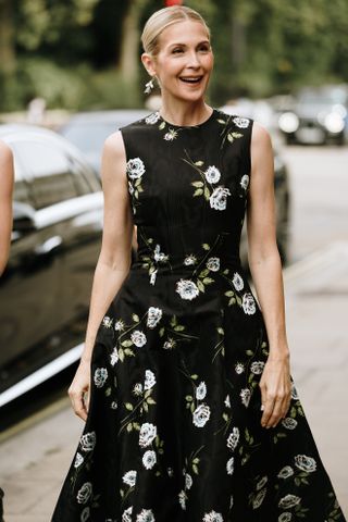 woman in dark black floral dress