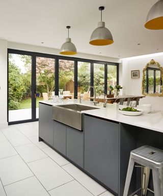 Kitchen with gray cabinets and folding doors to patio