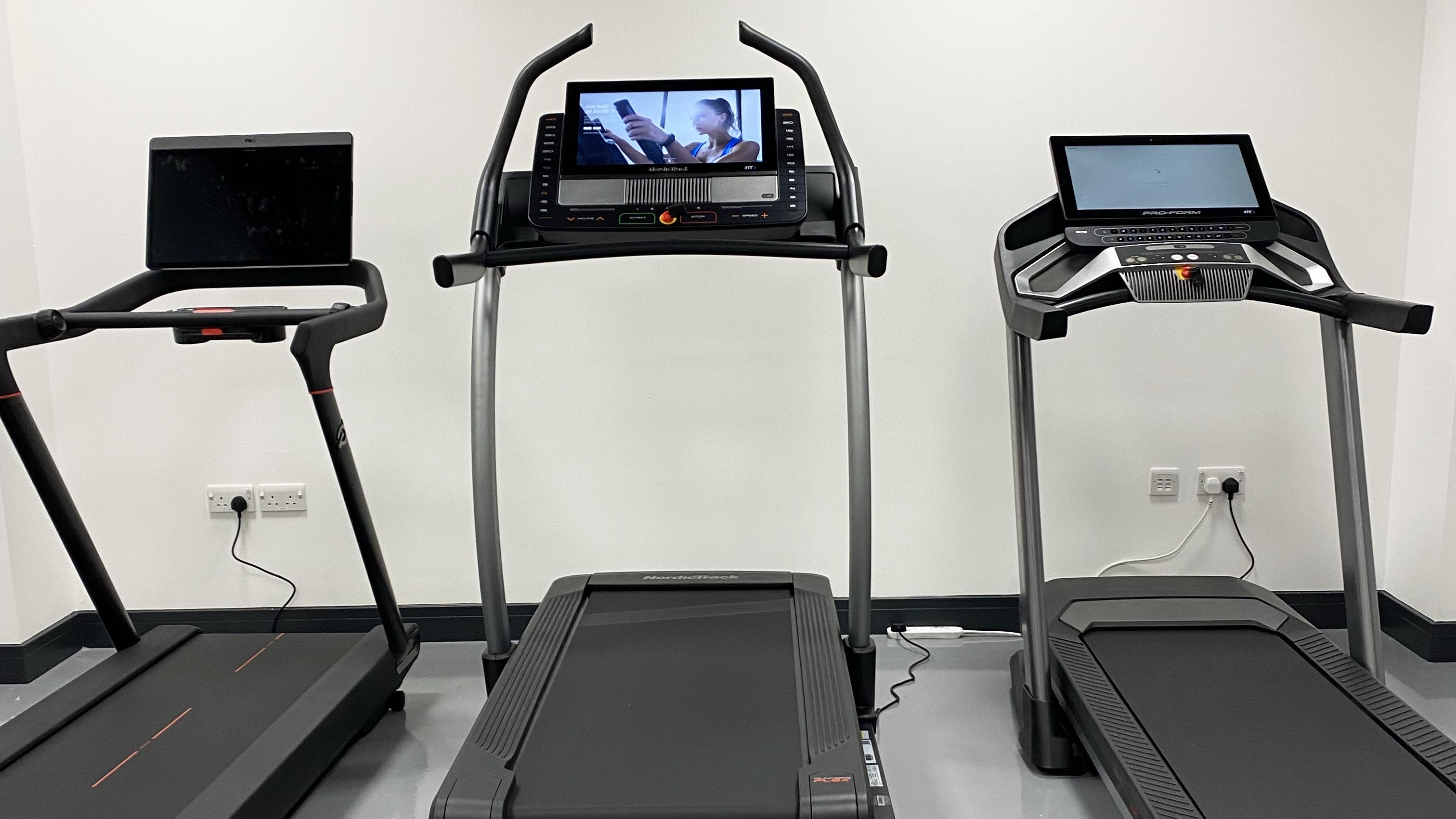 a photo of three treadmills