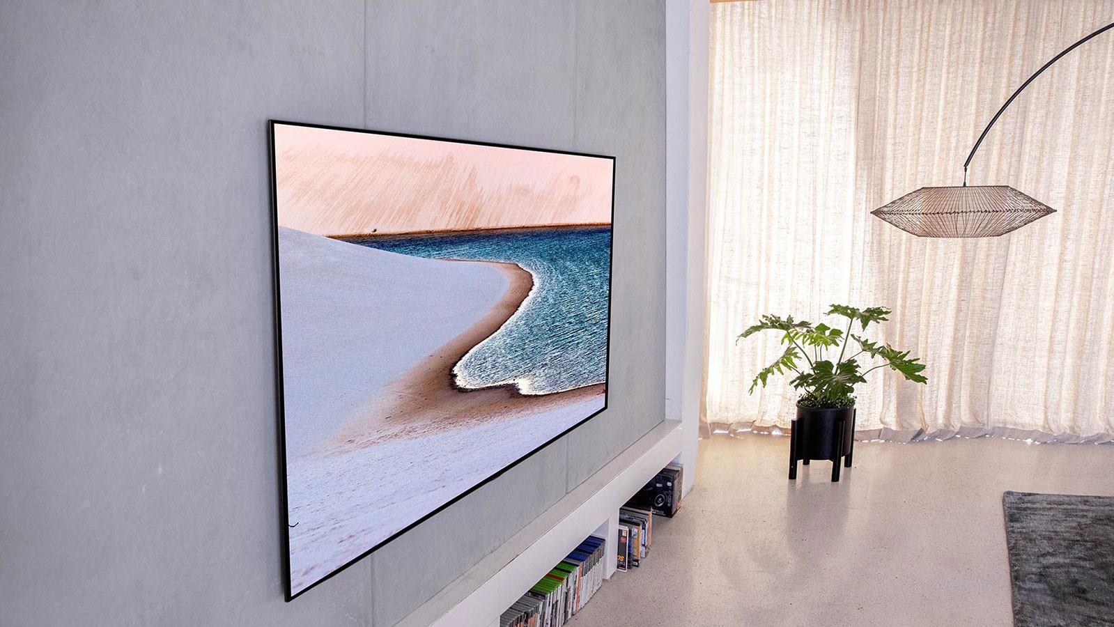LG Gallery Series OLED TV in a grey room beside a plant