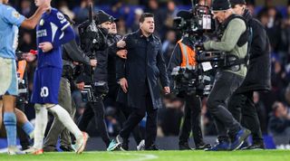 Mauricio Pochettino has to be restrained at full-time by colleagues after Chelsea's 4-4 draw against Manchester City in November 2023.