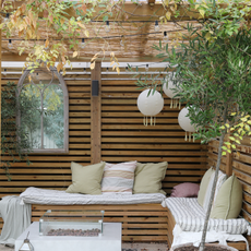  bench seat, cushions, fairy lights, fire pit, garden, lantern, outdoor, outdoor rug, pergola, plants, shelter, slat wall, tree.