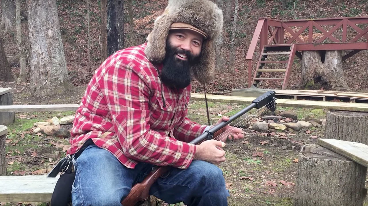 Rev. Peyton with shotgun guitar