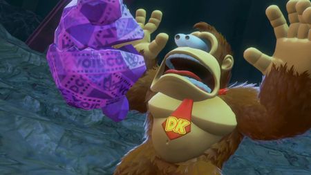 Donkey Kong Bananza screenshot shows DK looking shocked, with his hands in the air and eyes popping out of his head.
