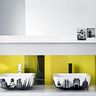 bathroom with washbasin and yellow with black striped splashback