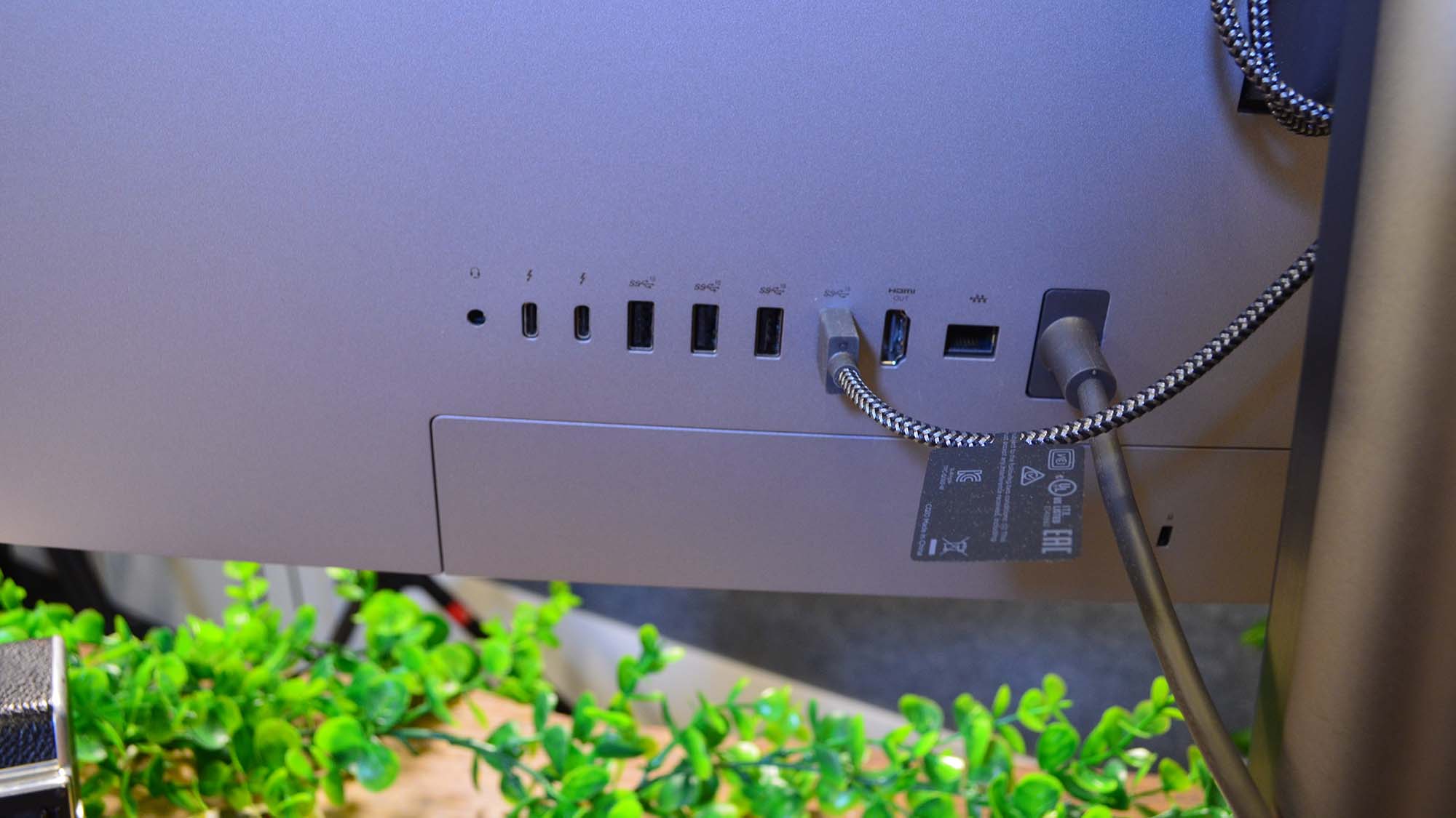 An HP Envy 34 on a desk in front of a plant