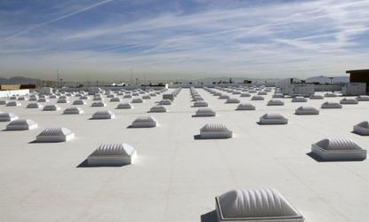 While white roofs, like the one on this Las Vegas Walmart store, help reduce energy use indoors, the effect the white has on global warming is not as obvious.