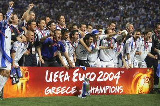Greek players and staff members pose with their trophy