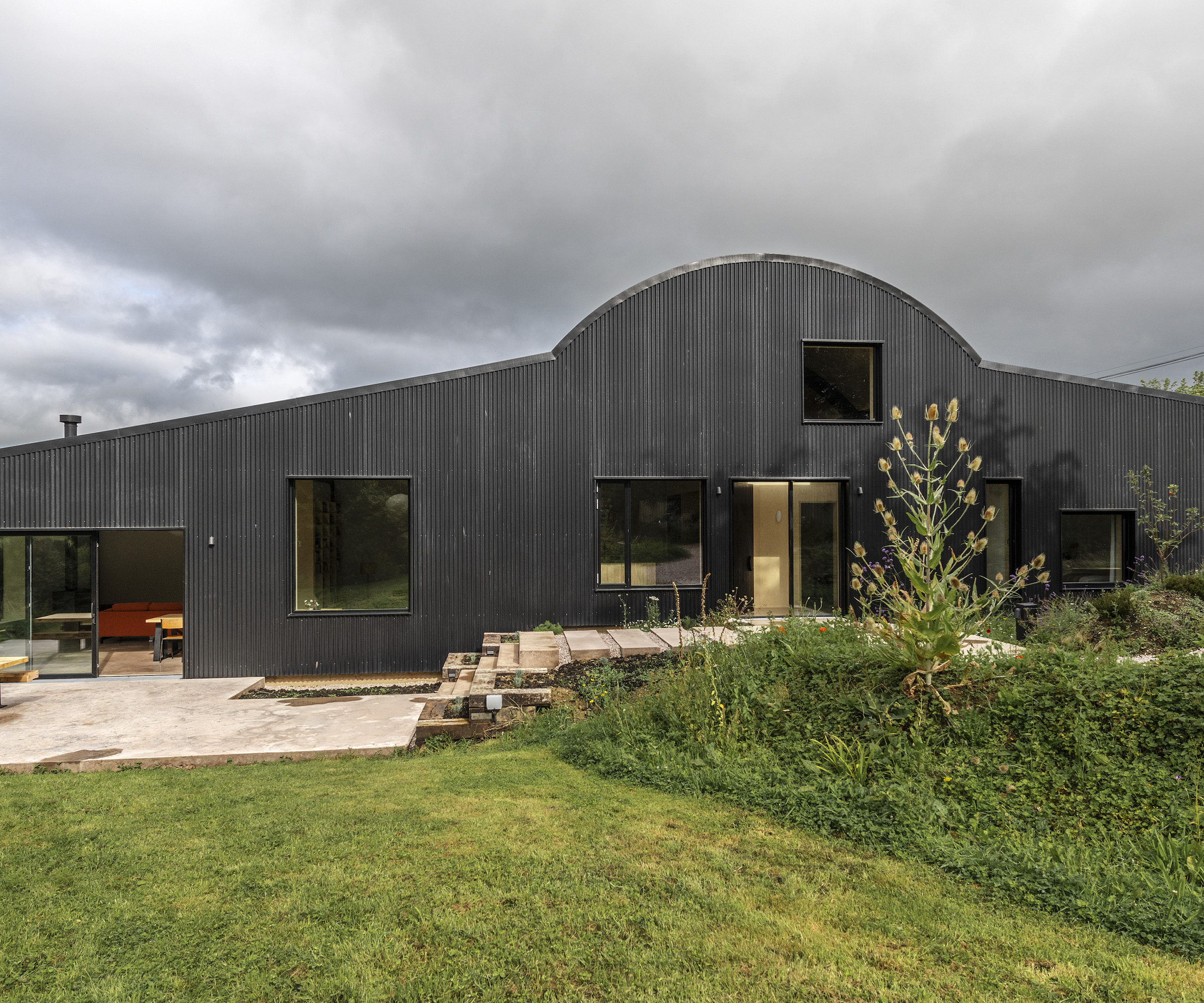 Exterior of a barn conversion clad in black zinc