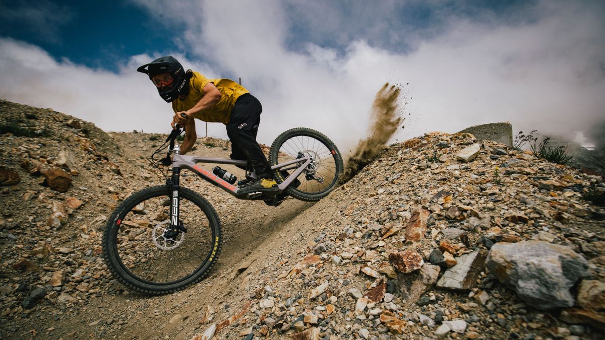 Sam Dale kicks up dirt while riding the Santa Cruz Nomad