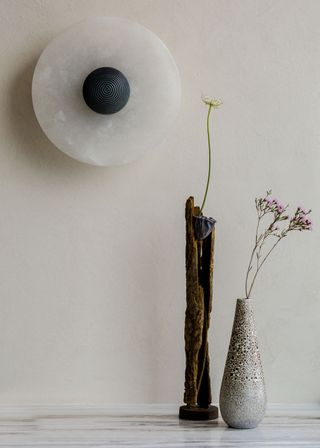 A pair of asymmetrical planters on a marble counter