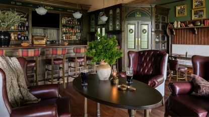 an authentic Irish pub built in a home in Tennessee with traditional bar, leather seating and antique decor