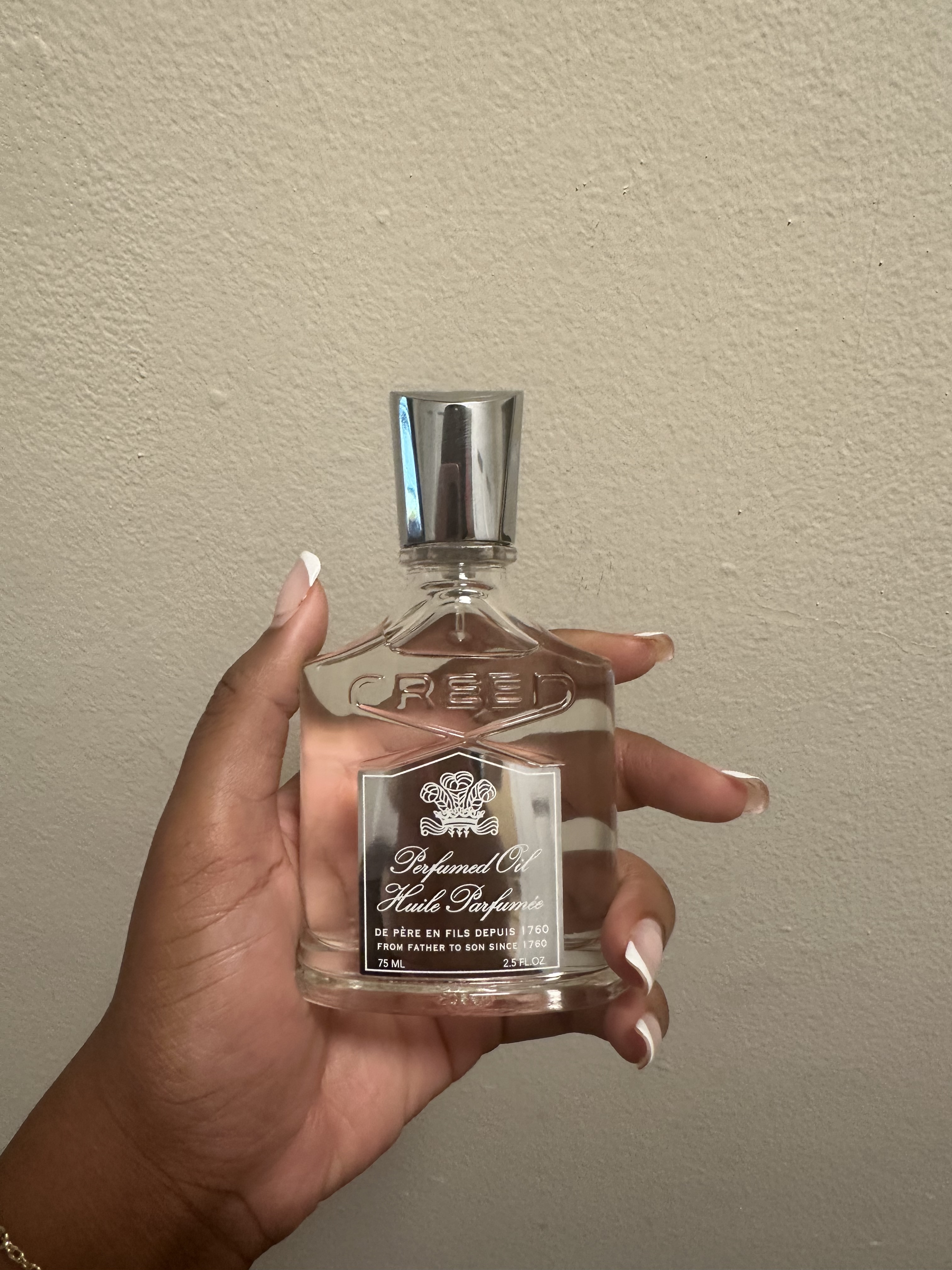 Ariel Baker testing Creed perfume oil