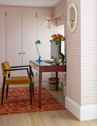Small home office with wrap around wallpaper on doors