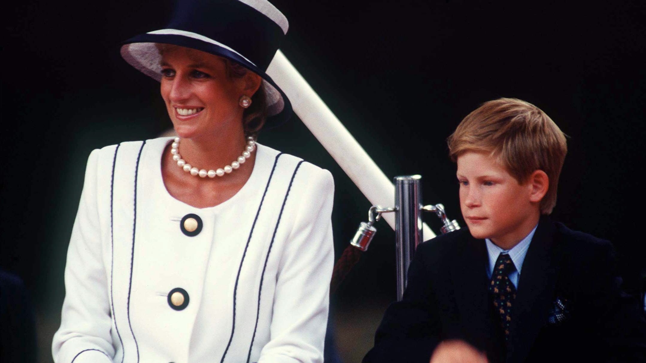 Princess Diana and Prince Harry sit together as they attend a VJ Day event in 1995