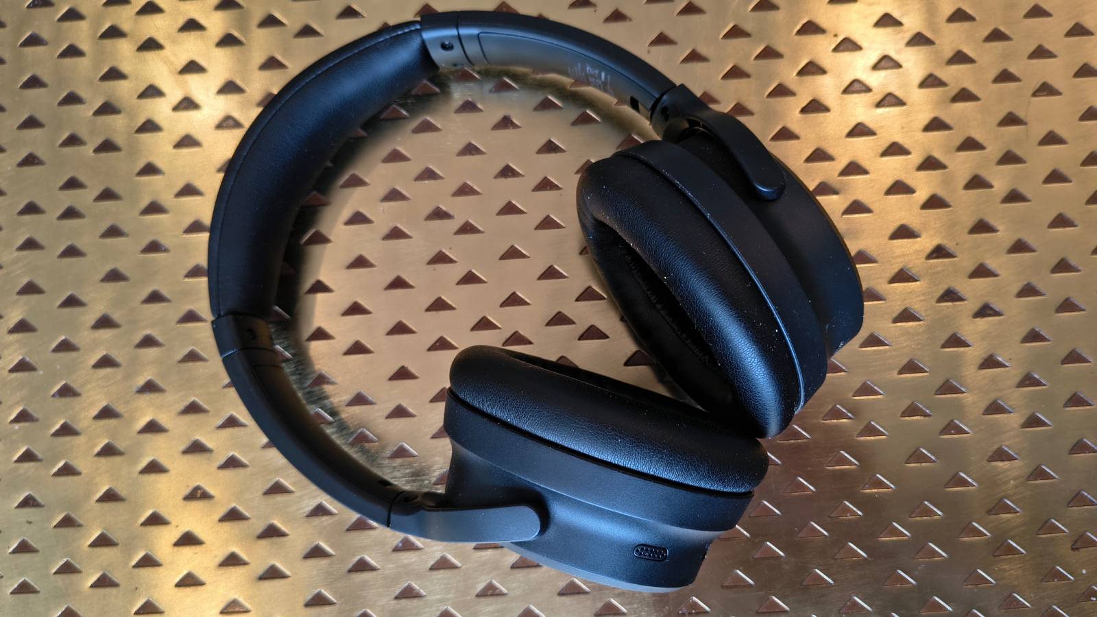 The Earfun Tune Pro atop a bronze table.