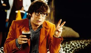Austin Powers: International Man of Mystery giving the peace sign while having a drink