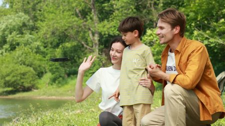 Best drones for kids: Pictured here, parents and a child looking at the HoverAir X1 drone