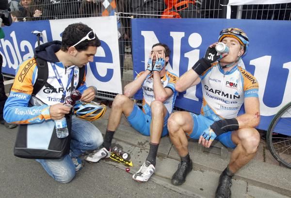 Spent: Garmin-Transitions teammates David Millar and Tyler Farrar at the finish of Flanders