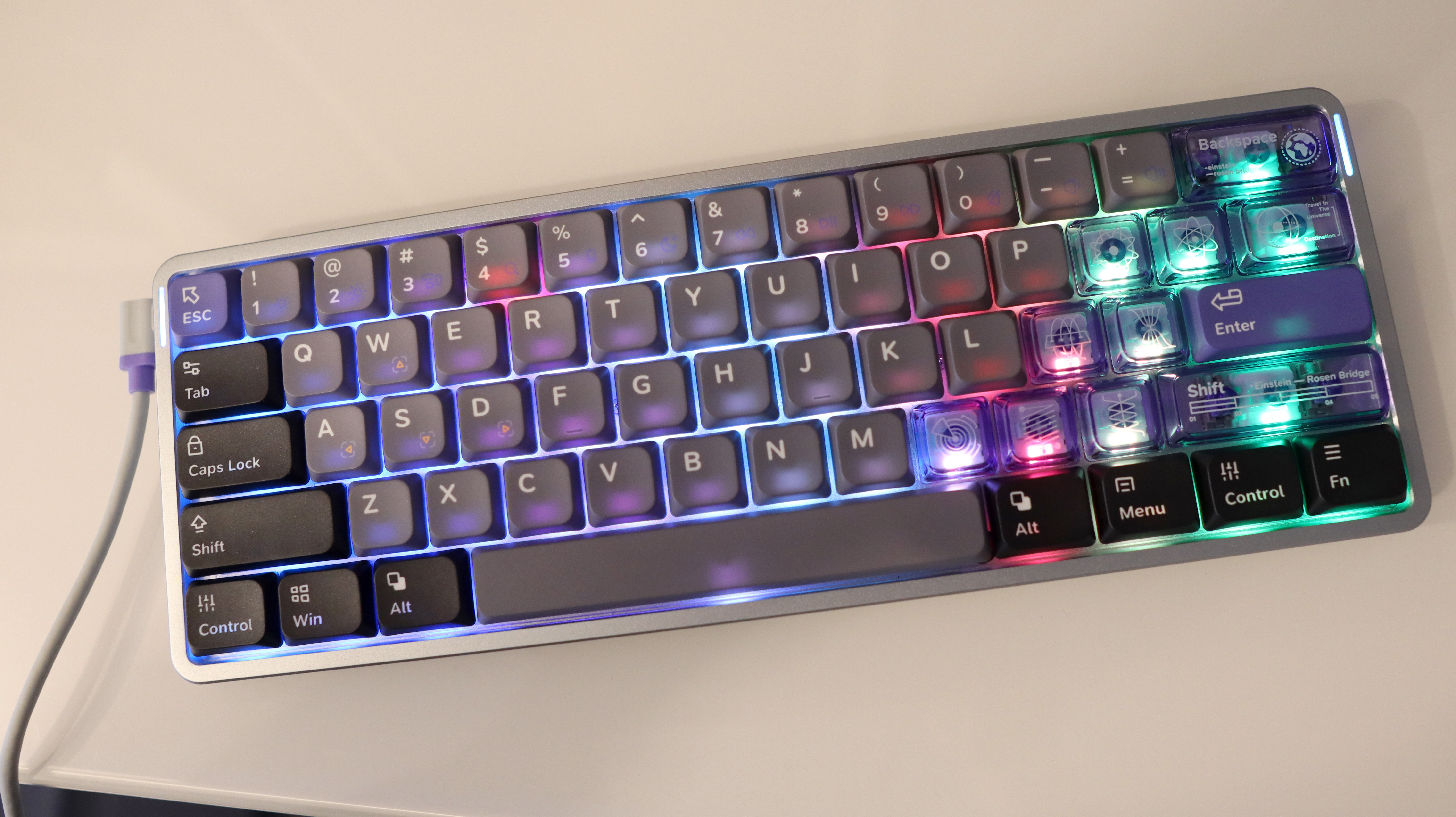 NuPhy Air60 HE gaming keyboard on a desk with RGB enabled.