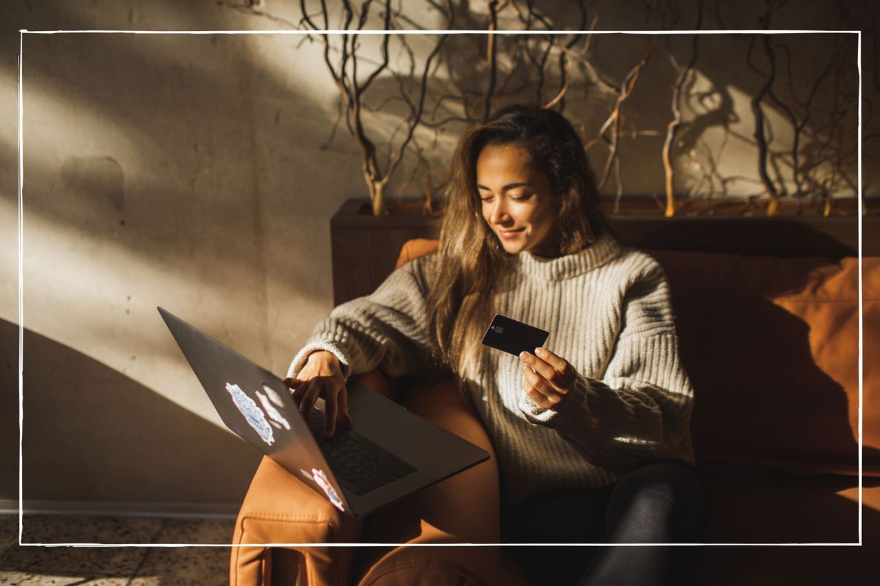 woman sitting on sofa while online shopping on her laptop