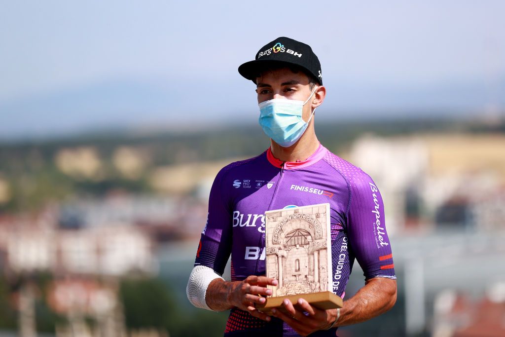 BURGOS SPAIN AUGUST 02 Jess Ezquerra Muela of Spain and Team Burgos BH celebrates winning the trophy for the most combative rider on the podium ceremony after the 44th Vuelta a Burgos 2022 Stage 1 a 157km stage from Catedral de Burgos to Mirador del Castillo Burgos VueltaBurgos on August 02 2022 in Burgos Spain Photo by Gonzalo Arroyo MorenoGetty Images