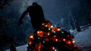 Tarman walking with a Christmas tree in the Return of the Living Dead trailer