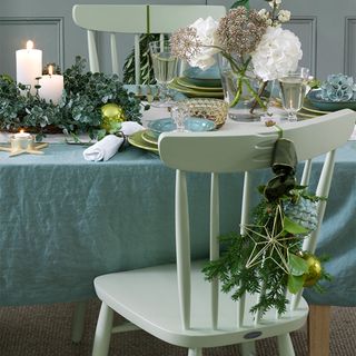 christmas dinning table with white chair and flower pot