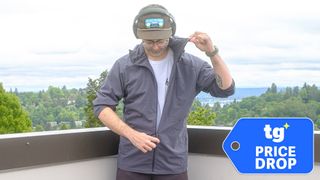 Senior writer Dan Bracaglia wearing the Patagonia Nano-Air Ultralight in grey/blue on the roof of his home in Seattle, Washington with trees and overcast skies in the distance