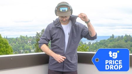Senior writer Dan Bracaglia wearing the Patagonia Nano-Air Ultralight in grey/blue on the roof of his home in Seattle, Washington with trees and overcast skies in the distance