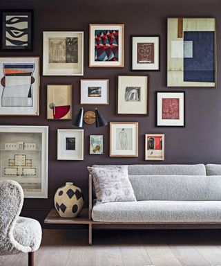 Grey couch, galler wall, vase, wooden floor