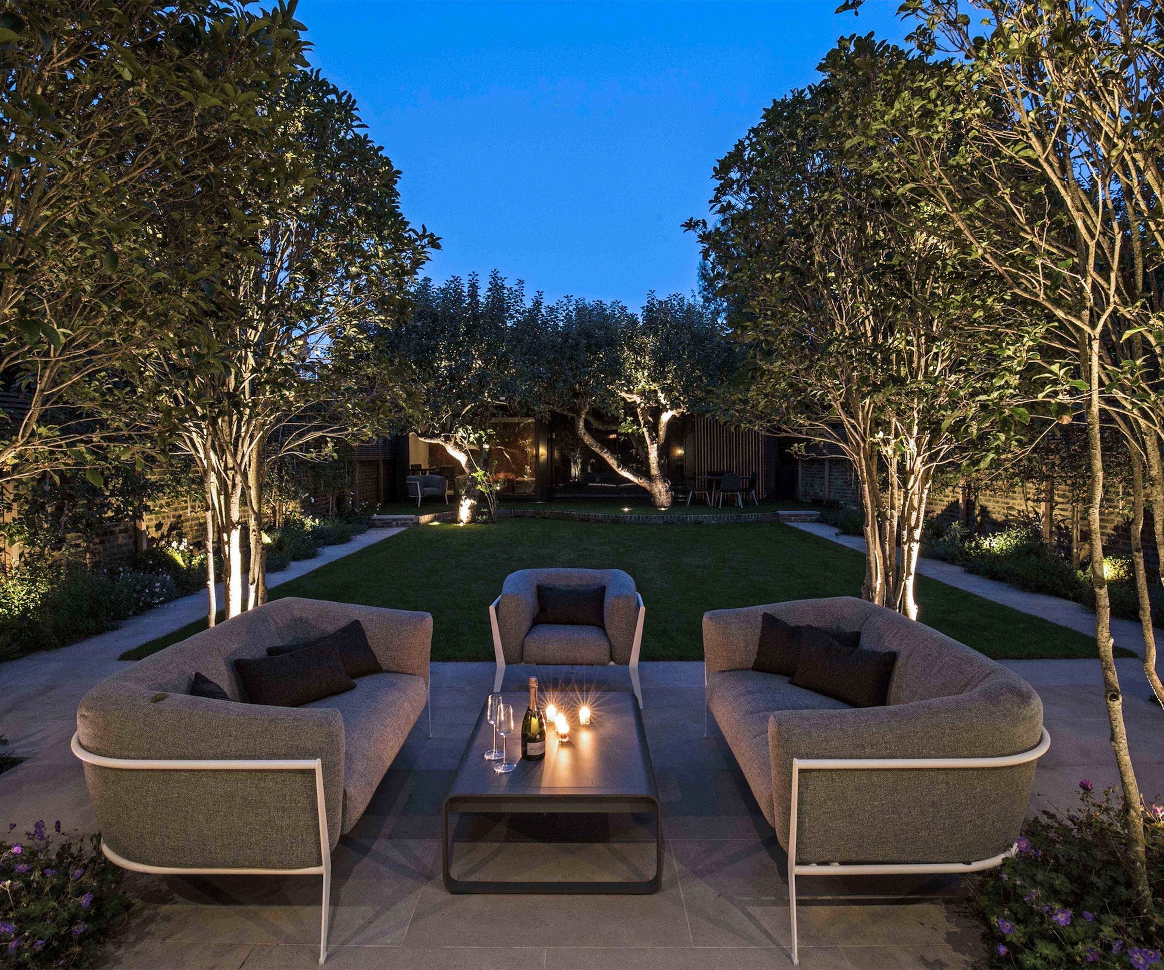 A rectangular garden with a central lawn and paved pathway