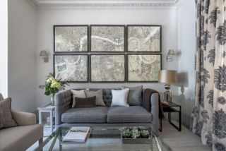 Grey sofa, glass coffee table, 6 London map pictures