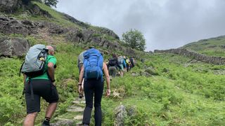 A group of hikers make their way uphill