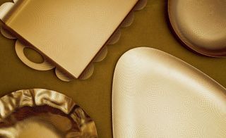 Alessi's tableware in a punched brass finish