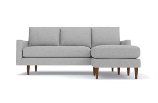 A gray chaise sectional sofa with dark wood legs from APT2B