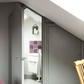 Loft room converted into a bedroom with an en-suite that's been painted in a grey colour