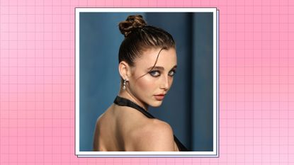 Emma Chamberlain wears a backless, black satin dress as she attends the 2022 Vanity Fair Oscar Party hosted by Radhika Jones at Wallis Annenberg Center for the Performing Arts on March 27, 2022 in Beverly Hills, California./ in a pink check template