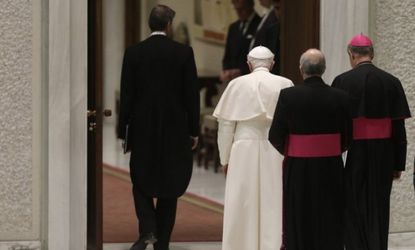 Pope Benedict XVI leaves at the end of his weekly general audience in the Paul VI Hall at the Vatican on Feb. 13. 