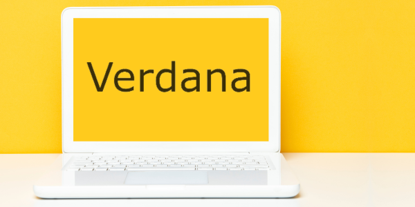 Verdana font seen on yellow laptop screen against yellow wall