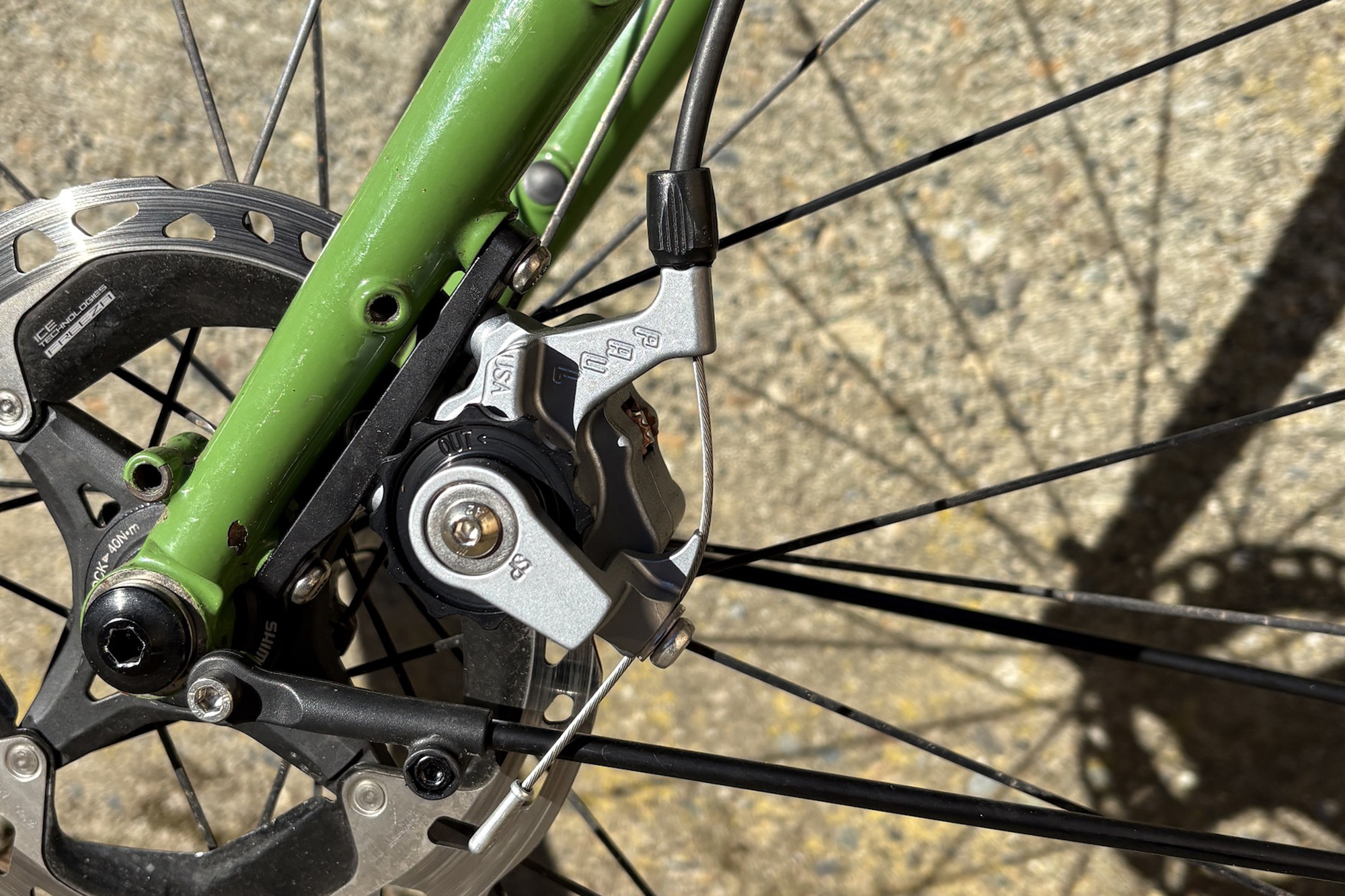 Paul Components Klamper disc brake mounted to Green fork leg with shimano disc rotors