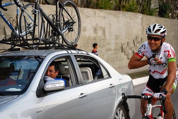 Jorge Martinez (Colombia) loads up on water bottles at his team car.