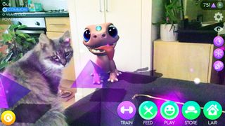 A screenshot of an AR game in which a pink AR Dragon appears in a kitchen next to a cat