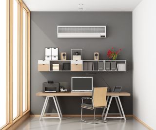 Home workplace with desk, bookcase, AC vent and large window