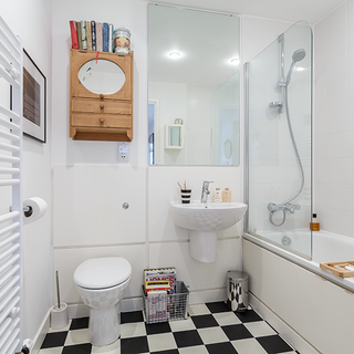 bathroom with mirror and black white flooring tiles