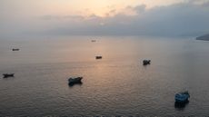 Ships wait off the coast of Oman in Strait of Hormuz