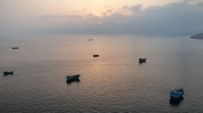 Ships wait off the coast of Oman in Strait of Hormuz