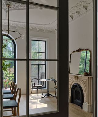 A shot of a brownstone kitchen taken from outside a glass doorway