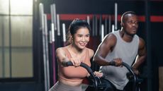 Man and woman on exercise bikes undergoing HILIT training