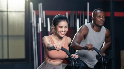 Man and woman on exercise bikes undergoing HILIT training